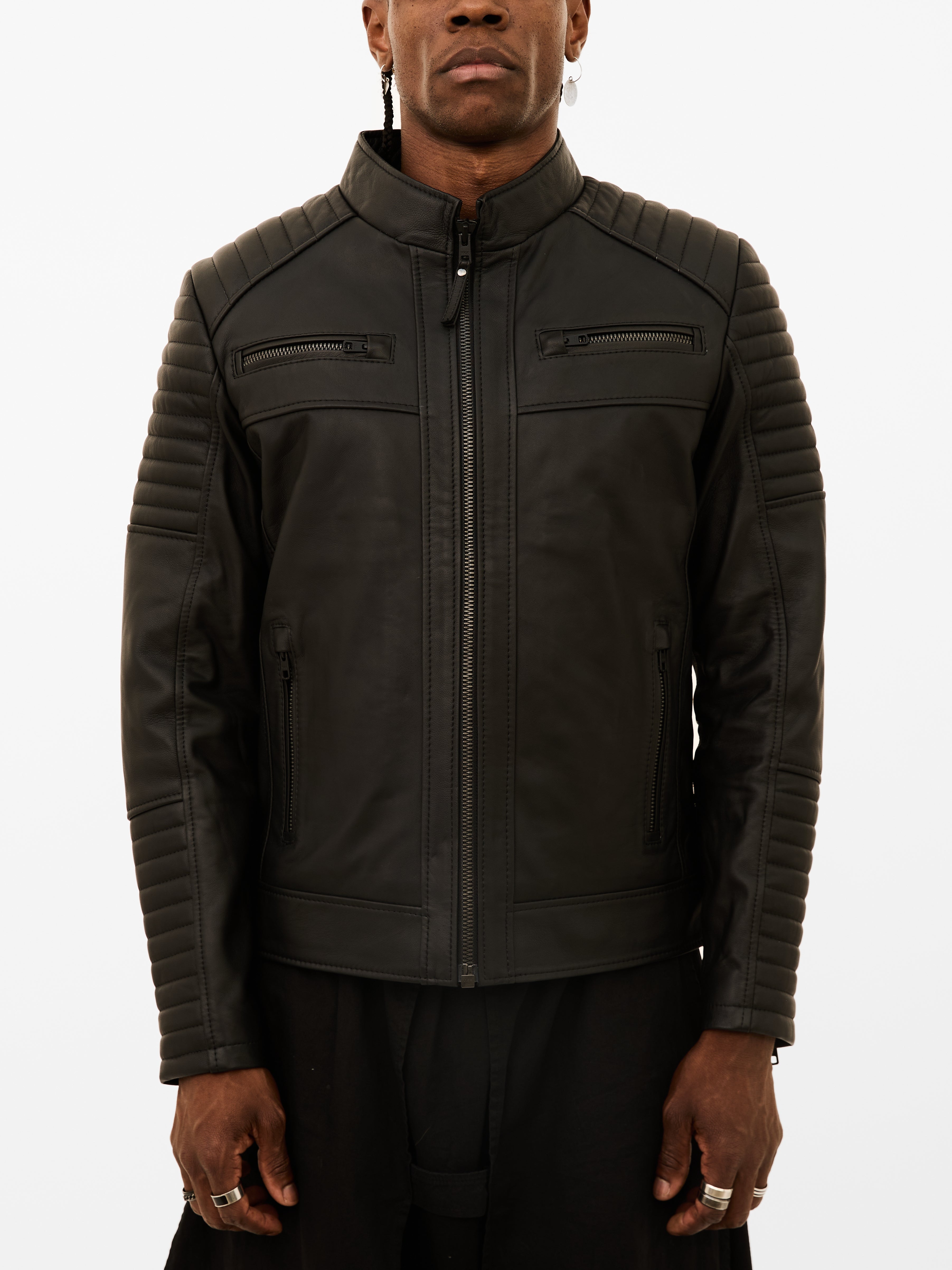 Man wearing a black leather jacket on a white background