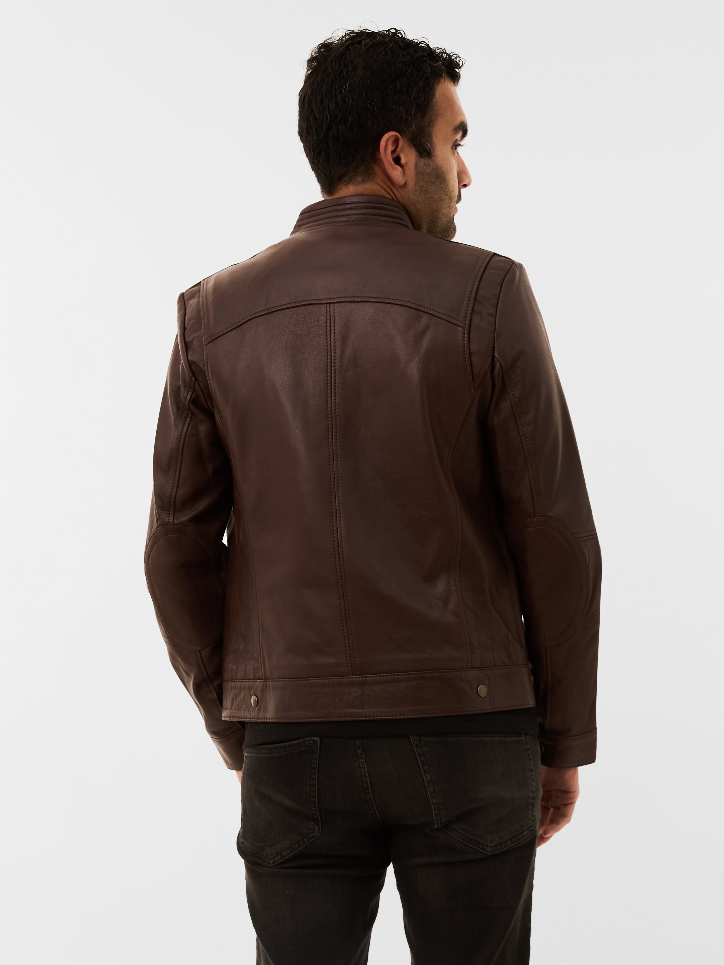 Man wearing a brown leather jacket on a white background