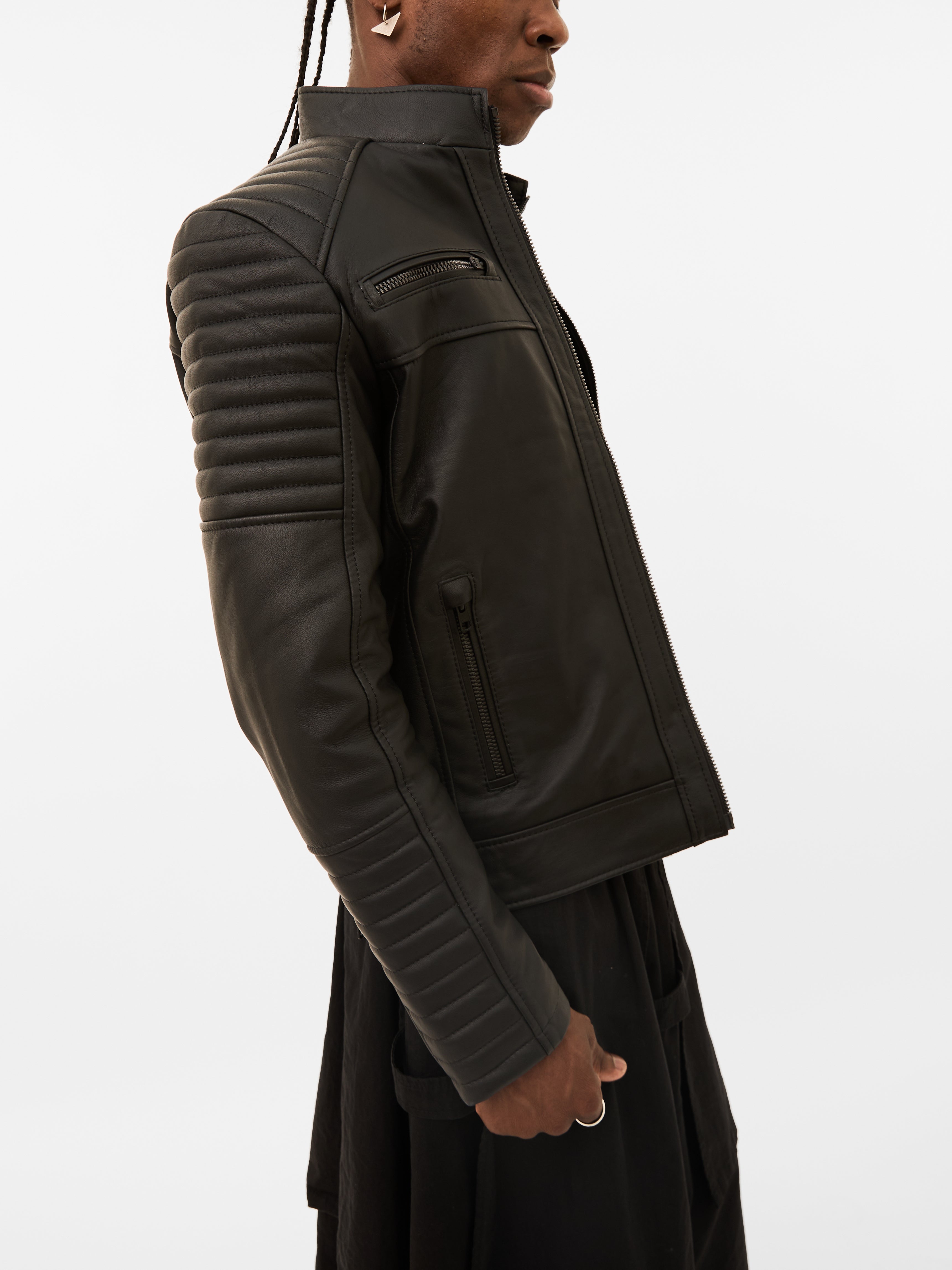 Person wearing a black leather jacket on a white background