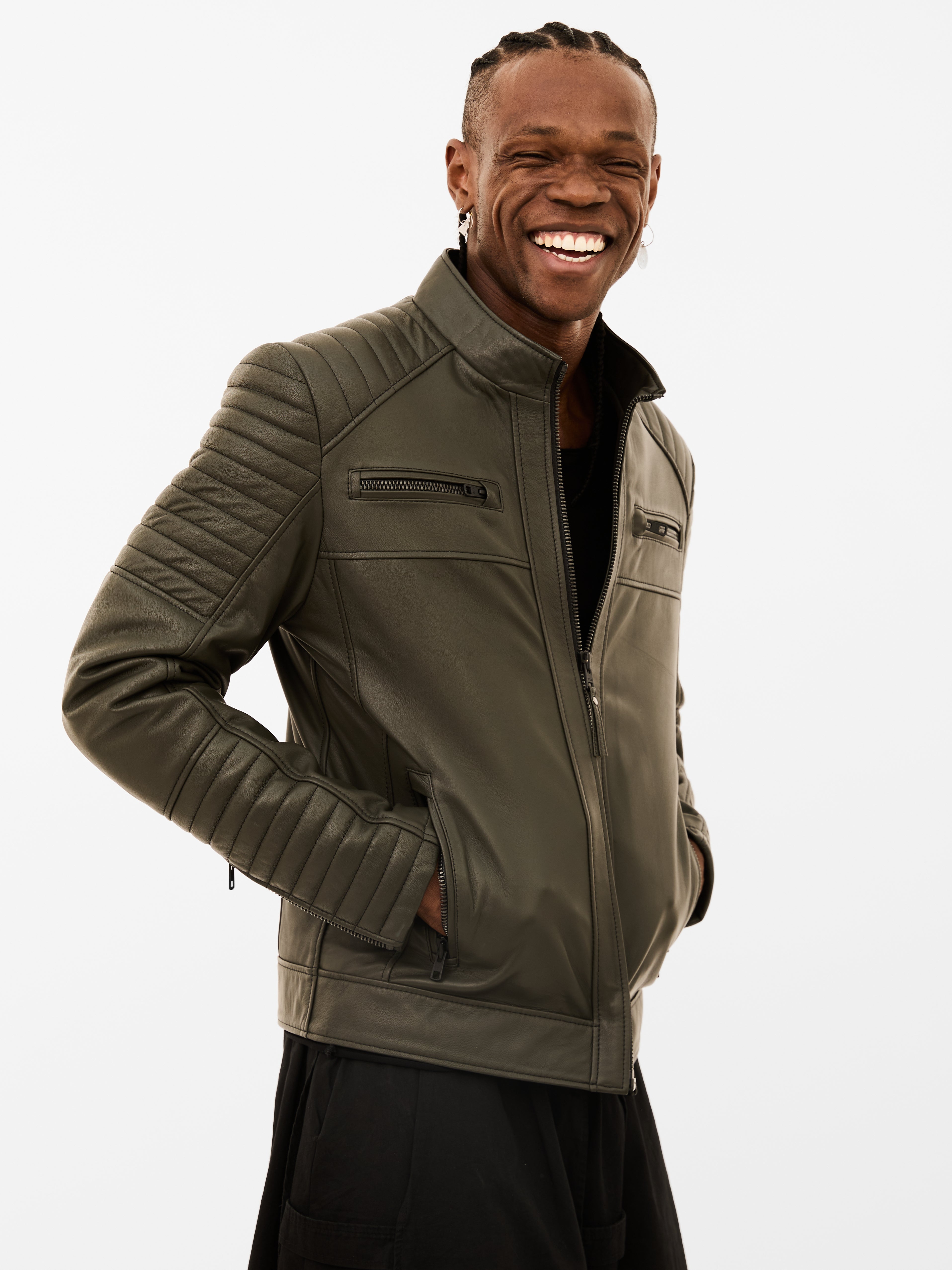Man wearing a green leather jacket on a white background