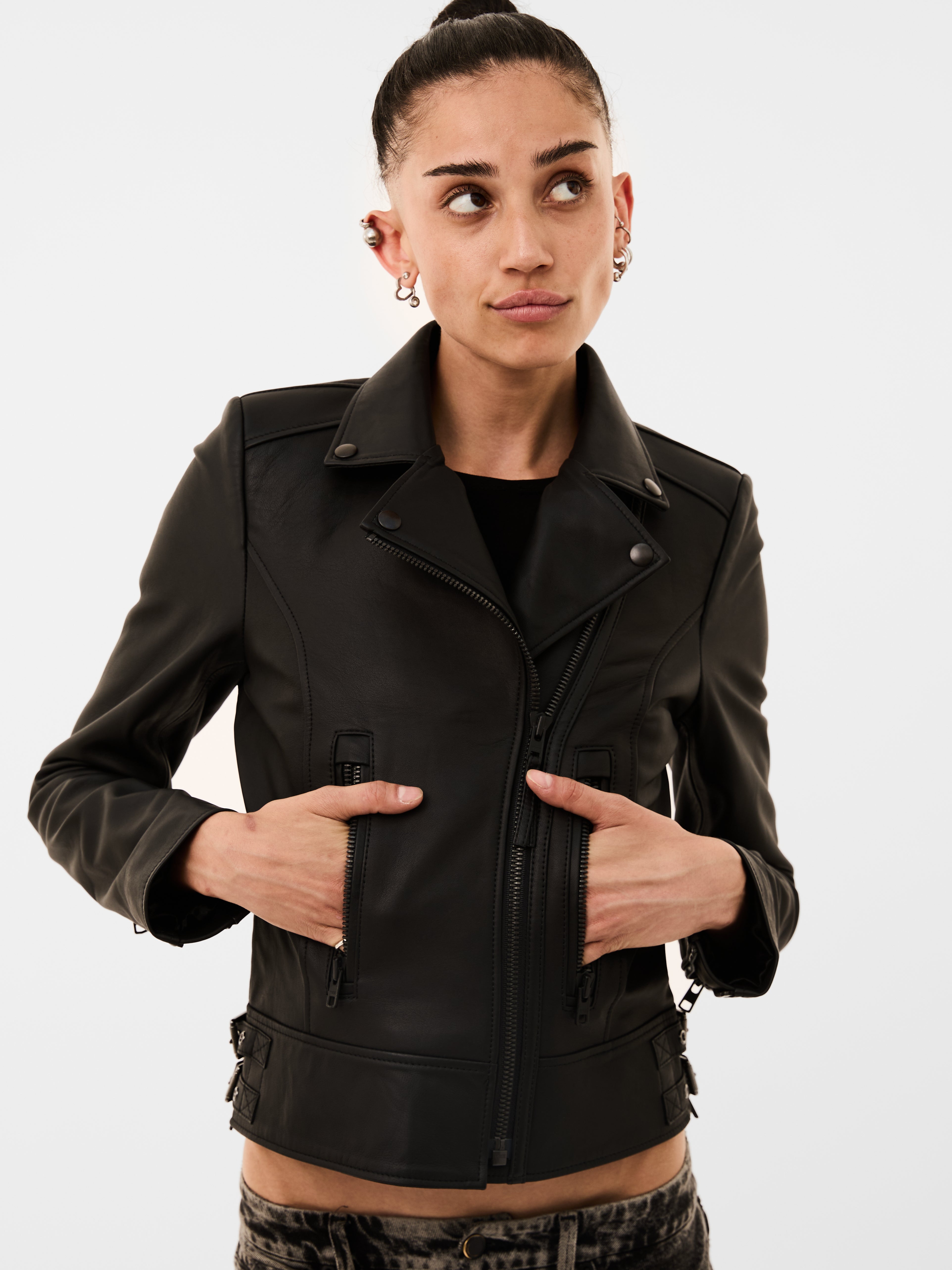 Person wearing a black jacket on a white background